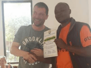 Ian Jenkins receiving the summit certificate from one of the guides from Kandoo Adventures.